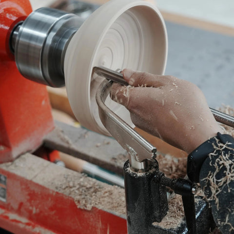 BMWOOD 1in stem-glide bowl-turning toolrest in-use on wood lathe; front view of gloved hand shaping a white bowl.