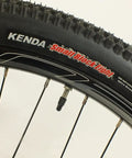 Close-up of Salire SJ-50 Dirt Jumper Bike With Disc Brakes And 26 Inch Wheels showing small block tires and double walled rims.