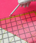 Game Changer Clear Acrylic Quilting Ruler Set for Precise Cutting with green markings on pink background