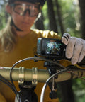 Premium Waterproof Action Camera Bundle With 5.3K60 Video And 27Mp Photos mounted on a bike handlebar for extreme sports.