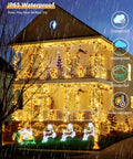 2Pack 500LED Solar String Lights Outdoor Waterproof 180FT With 8 Modes IP65 Warm White Twinkle illuminating house in rain
