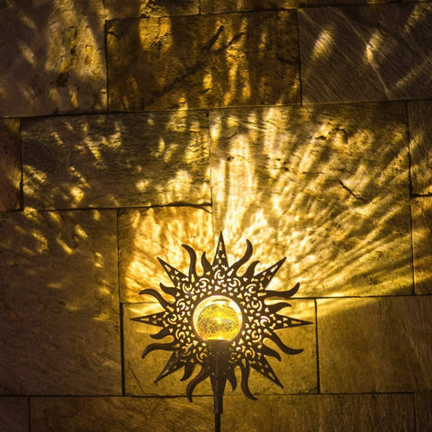 Outdoor Solar Garden Stake Lights Weatherproof Metal Pathway Lighting casting sun patterns on wall at dusk
