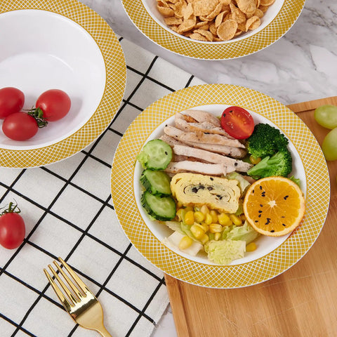 Sturdy Reusable Plastic Bowls With Gleaming Gold Grid Rim, 12 Ounce White Bowls featuring colorful food on a tabletop.
