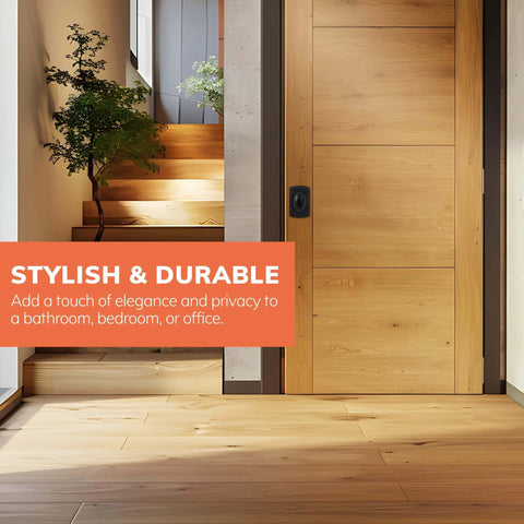 Stylish matte black privacy door knob installed on wooden door for bathroom, bedroom or office, enhancing decor and functionality.