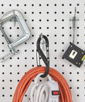 Dual Gate S Shaped Plastic Carabiner With Two Clips For Keys And Gear hanging on pegboard with tools and cables