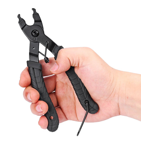 Hand holding black ergonomic 2 In 1 Bike Master Link Pliers For Quick Link Removal Opener And Closer Heavy Duty Chain Repair Tool.
