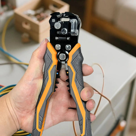 Hand holding 5 In 1 Self Adjusting Wire Stripper Kit with Automatic Wire Stripper for AWG 24 to 10, showcasing gripped handles