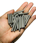 Hand holding 35 Pieces 6mm By 40mm Dowel Pins Set In Stainless Steel 304 For Shelves, Bunk Beds And Wood Projects, M6 Round Pegs
