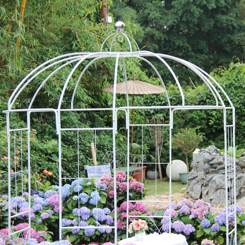 Birdcage Garden Arch Arbor 9 Ft High By 6.8 Ft Wide White Metal Gazebo With Anti Rust Wrought Iron Frame in garden setting with flowers.
