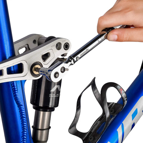 Cyclist using Gear Up Bike Torque Wrench Set 1/4 Inch Drive With Hex And Torx Bits 2-20 Nm Click Wrench on bike frame.