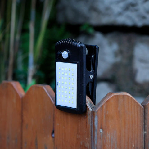4 Pack Solar Motion Sensor Clip Lights With 40 LEDs on wooden fence, waterproof outdoor security lights, 2 modes
