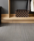 Top Shelf Clothing Storage Bin With Reinforced Metal Frame And Grippy Polyester Weave Handles on wood shelf with gray carpet.
