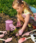 Child using Kids Garden Gear 14-Piece Tool Kit With Tote Bag Watering Can Apron Rake Shovel Trowel Gloves Garden Book STEM