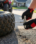 Person using steel tool from Badass Heavy Duty 31 Piece Flat Tire Repair Kit on ATV tire for quick roadside fix.