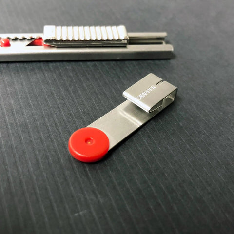 Close-up of Auto Lock Stainless Steel Utility Knife With 9mm Blade Built In Snapper Pocket Clip Ambidextrous Tool.