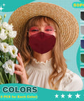 Woman in a hat wearing a red Essential KN95 Face Masks 50 Pack Individually Wrapped Multicolor For Men And Women, 5 Layer, holding flowers.