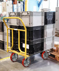Heavy Duty Eight By Two Inch Industrial Casters Polyurethane And Steel Wheels Six Thousand Pound Capacity Built Tough For Shop Carts And Utility Dollies Rolls Easy No Sweat Swivel Lock Brakes Pack Of Four on a cart with stacked crates.