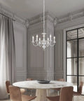 French Country Chandelier 6 Light Modern Farmhouse Vibe For Dining Room And Kitchen, Rustic White Metal Candle Style Pendant Light in a vintage dining room.