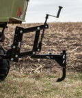 Middle Buster Furrower Attachment For Subsoil Work From Impact Implements attached to tractor, ready for soil preparation.
