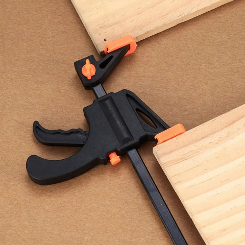 Close-up of 4 Inch Bar Clamps For Woodworking 5 Piece Trigger Quick Grip Clamps with One Handed Ratchet holding wood pieces.
