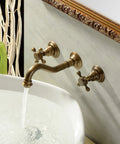 Antique Brass Bathroom Sink Faucet Set With Ceramic Disc Valve installed on wall, showing water flow into a white basin.