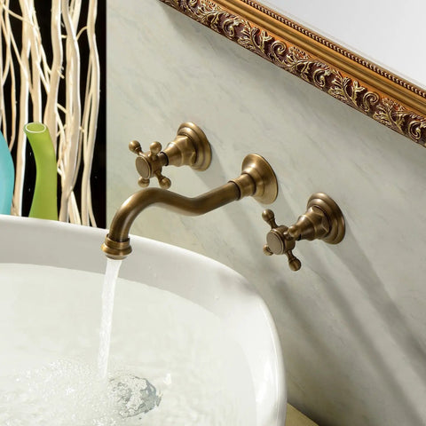 Antique Brass Bathroom Sink Faucet Set With Ceramic Disc Valve installed on wall, showing water flow into a white basin.