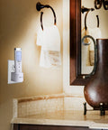 Go-To Motion Sensor LED Flashlight Night Light plugged in bathroom, illuminating the countertop with ambient light.