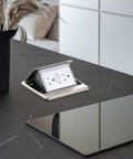 Pop Up Floor Electrical Outlet With 20 Amp GFCI, Stainless Steel Hidden Countertop Box open on black kitchen countertop