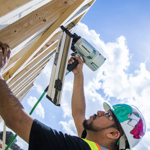 Construction worker using Framing Nailer For Pro Builders, Lightweight Pneumatic Power Tool Built For Floor Wall And Roof Decking