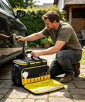 Man using Heavy Duty Steam Cleaner Storage Tote With Flexible Slots For Holding Every Wand Filter And Spray Nozzle for car cleaning.
