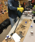 Person cleaning rifle parts using Gun Scrubber Cleaner 15-Ounce Aerosol For Fast Evaporating, Deep Cleaning Of Metal Firearm Parts