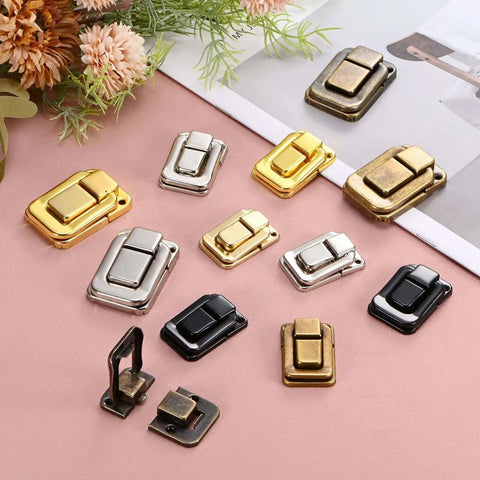 Six Pack Built Tough Metal Toggle Catch Locks With Mounting Screws For Jewelry Cases And Wooden Crates Sturdy Hasp Latches arranged on a pink surface.