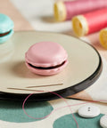 Sweet N Sharp Macaron Sharpener And Needle Minder Raspberry For Precise Sewing, Easy Needle Care, Quick Fixes On The Fly, Compact Crafting Tool For Quilters And Stitchers, Keeps Points Sharp And Shafts Smooth, pink macaron needle minder on sewing tray