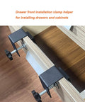 Two Pack Drawer Front Installation Clamps for Cabinets and DIY Woodworking Projects, Adjustable Drawer Fixing Clips with 0.65 to 2 Inch Range attached to a wooden drawer, demonstrating easy and stable drawer front mounting for hands-free installations.