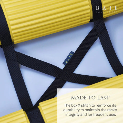 Close-up of Two Tank Scuba Cylinder Rack with box X stitching, yellow foam guards, and nylon straps for secure storage.