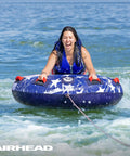 Airhead Stars And Stripes Towable Tube For 1 Rider Boating And Water Sports Made In The USA Heavy Duty Full Nylon Cover Patented Speed Safety Valve For Easy Inflation And Deflation Foam Padded Handles, front view on water