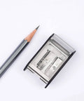 Two Step Long Point Pencil Sharpener With German Steel Blades In White Matte Finish next to sharpened pencil showing precise point