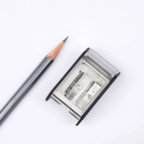 Two Step Long Point Pencil Sharpener With German Steel Blades In White Matte Finish next to sharpened pencil showing precise point