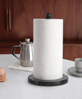 Blue Pearl Granite Paper Towel Holder for Kitchen Countertop with a roll of paper towels on granite base near coffee setup.