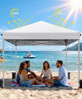 One Button Quick Setup 10x10 Pop Up Canopy With Carry Bag Portable Instant Shade Tent For Outdoor Events Parties Camping Includes 4 Sandbags And 8 Stakes White on beach with group of people under shade