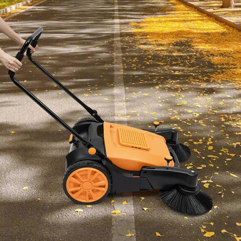 Walk Behind Floor Sweeper Featuring An Extra Wide 41 Inch Triple Brush Design, cleaning leaves off a concrete path.