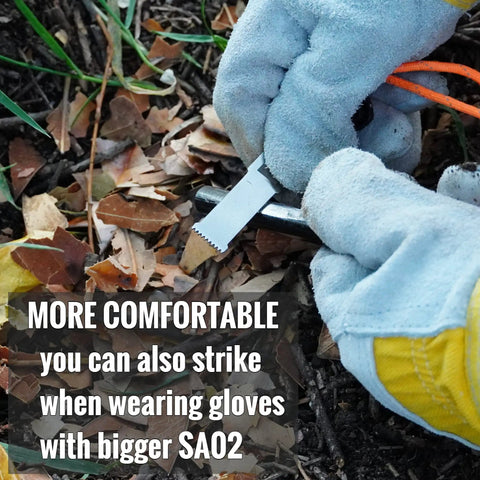 Two Pack Super Sharp Serrated Carbon Steel Ferro Rod Scraper For Fire Starting shown with gloved hand on leaves