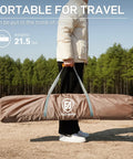 Person holding packed Pop Up Screen House Tent For Camping 11.5 By 9.8 Ft Instant Gazebo With Netting in khaki bag