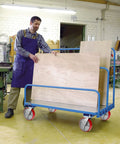 Rock Solid 8X2 Inch Swivel Casters Kingpinless Polyurethane Wheels on a workshop truck for moving plywood sheets.