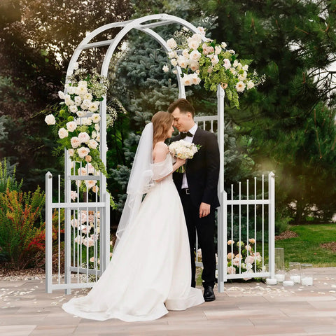 Couple under Garden Arbor With Gate PVC Frame Trellis Arch For Climbing Plants Outdoor Wedding Backdrop White Vinyl Pergola