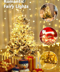 Decorated Christmas tree with snowman figures using 78Ft 240 LED Fairy Lights Battery Operated, cozy indoor scene with gifts.