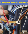 Close-up of insulated heat-shrink spade terminals with blue, red, and yellow sleeves and a ring terminal.