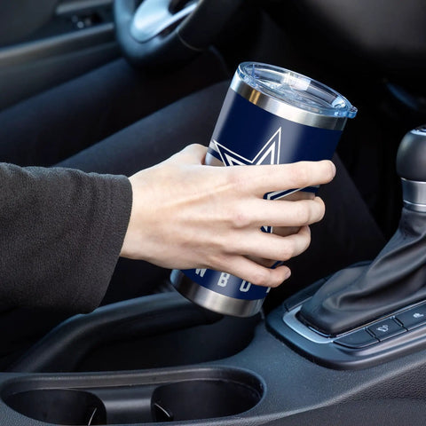 Make Every Sip Hit Different With This Dope 20 Oz Stainless Steel Tumbler Featuring Double Wall Insulation And Secure Lid For Dallas Cowboys Fans Who Want Their Coffee Tea Or Cocktails Staying Frosty All Day Long, held in a hand inside a car.