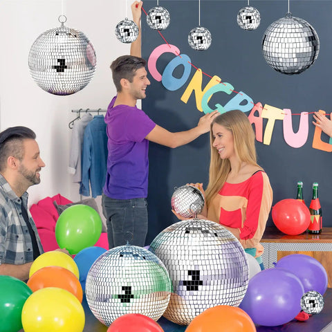 People decorating with 65 Piece Disco Ball Decor Set With Mixed Size Reflective Hanging Mirror Orbs For Weddings Parties Carnival