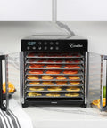 No Nonsense 8 Tray Food Dehydrator For Crankin Out Homestyle Beef Jerky Crispy Veggies And Sweet Fruit With Smart Temp Knob And 80 Hour Digital Clock Plus Hyperwave Air System displaying sliced fruits on chrome trays.